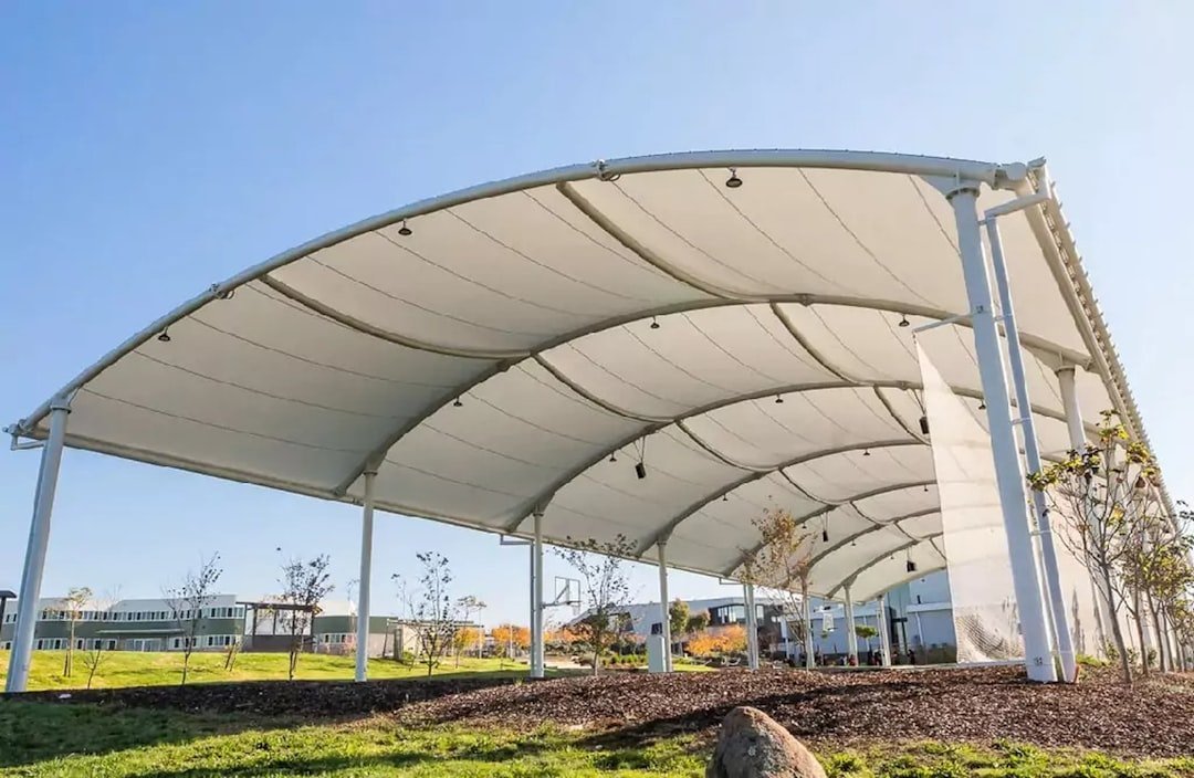 a white canopy provides shade in an open space 2mdo0kk7w0a.jpeg